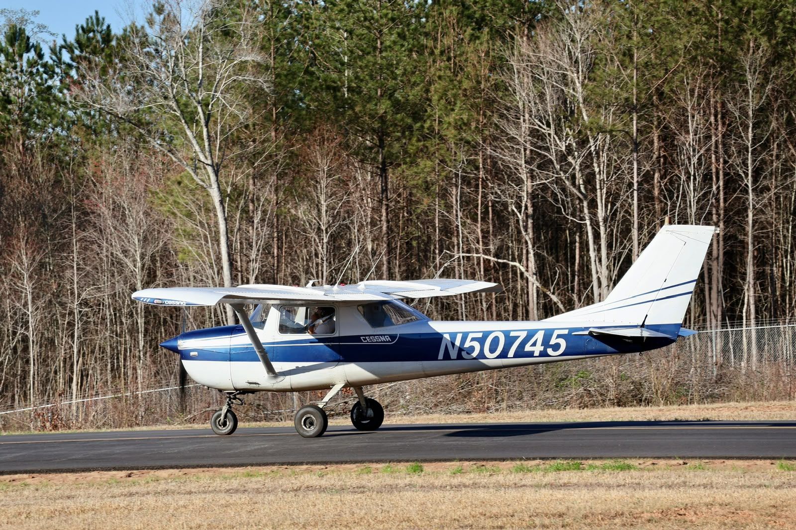 Cessna 150 parked on the tarmac, ready for flight training